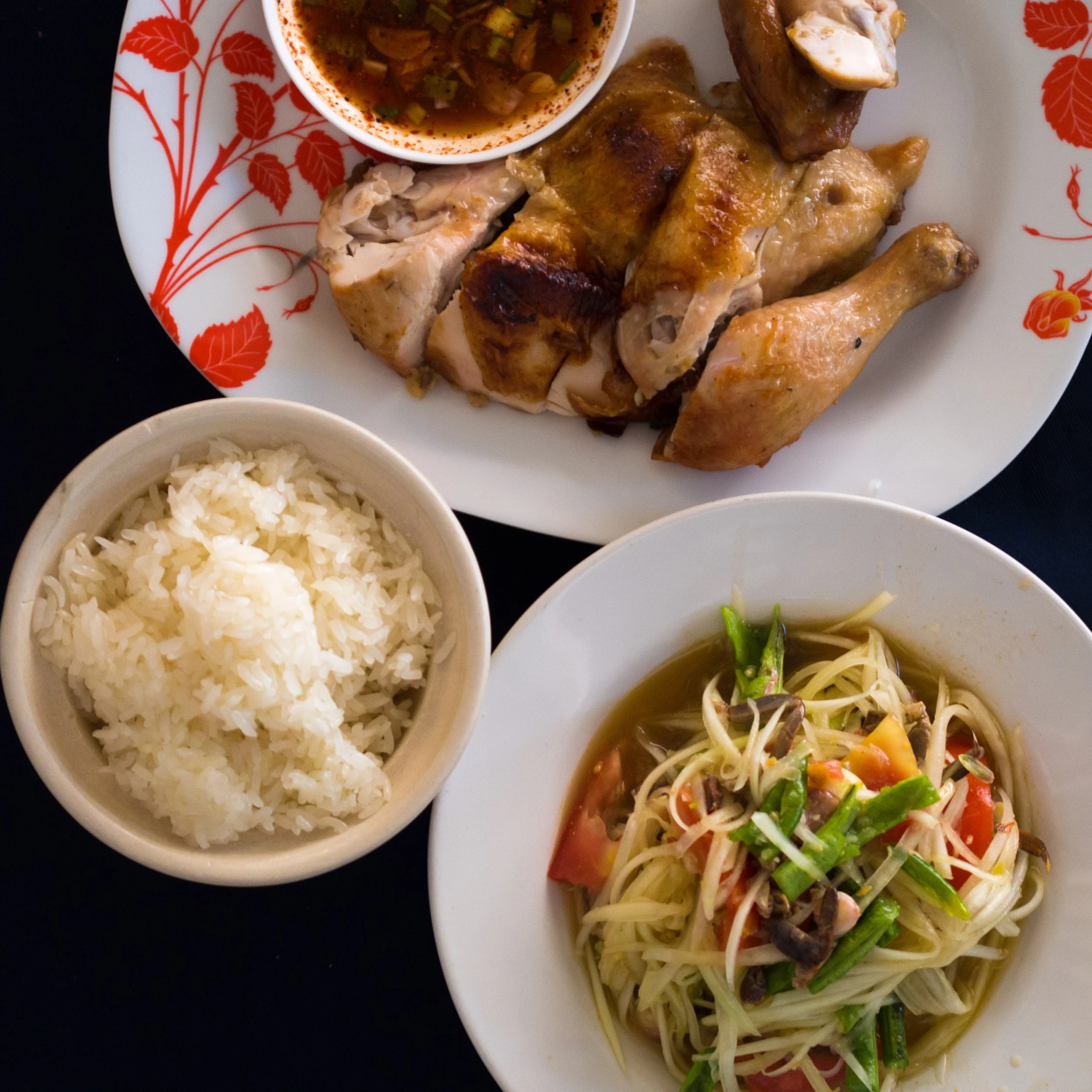 Som tam papaya salad, sticky rice and grilled chicken, classic Isaan food you find in Kalasin