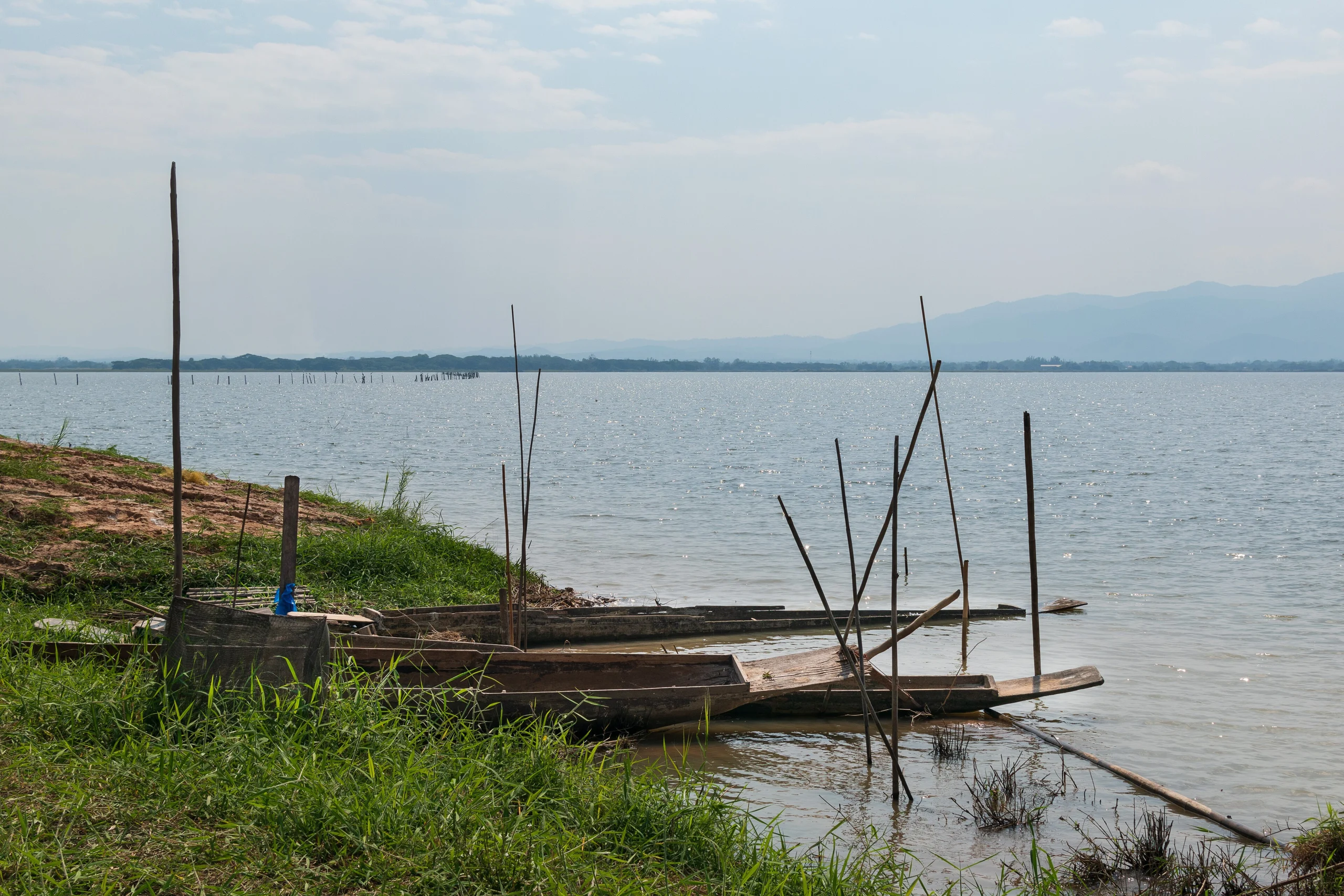 Small boats on the shore of Kwan Phayao lake