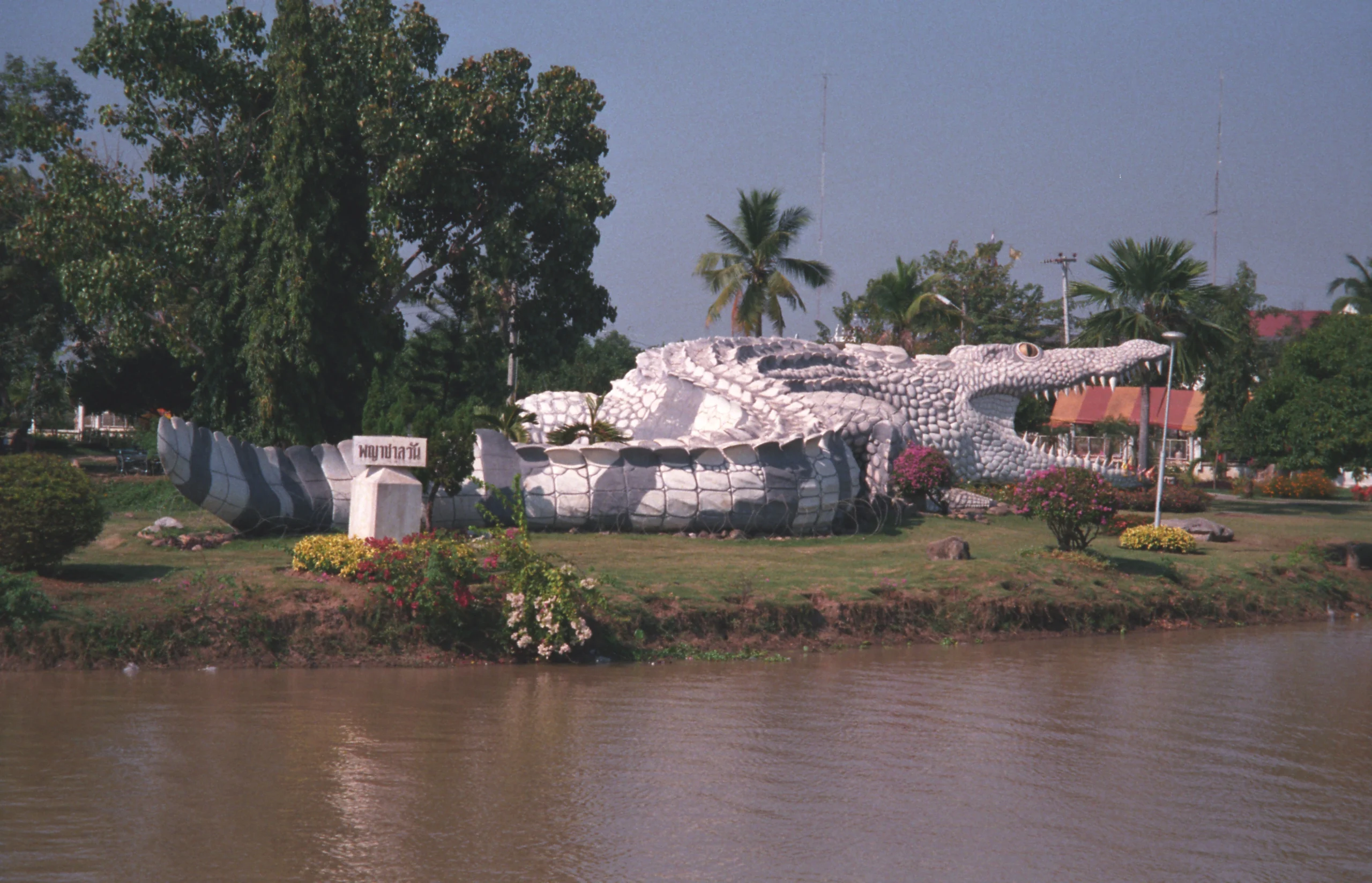 Giant Chalawan crocodile statue on the shore of Bueng Si Fai lake in Phichit