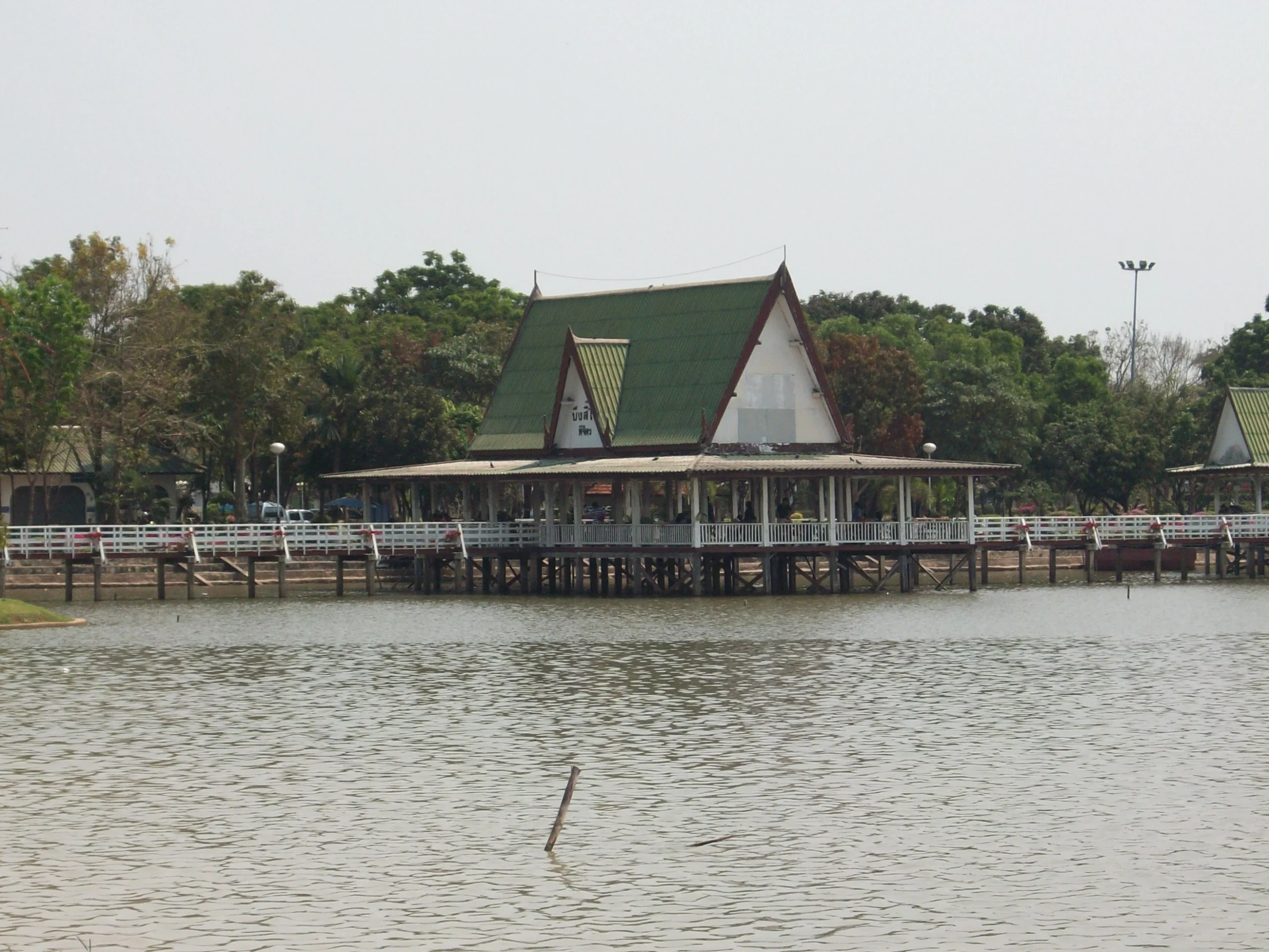 Lakeside pavilion over calm water in Phichit’s rice plains, central Thailand