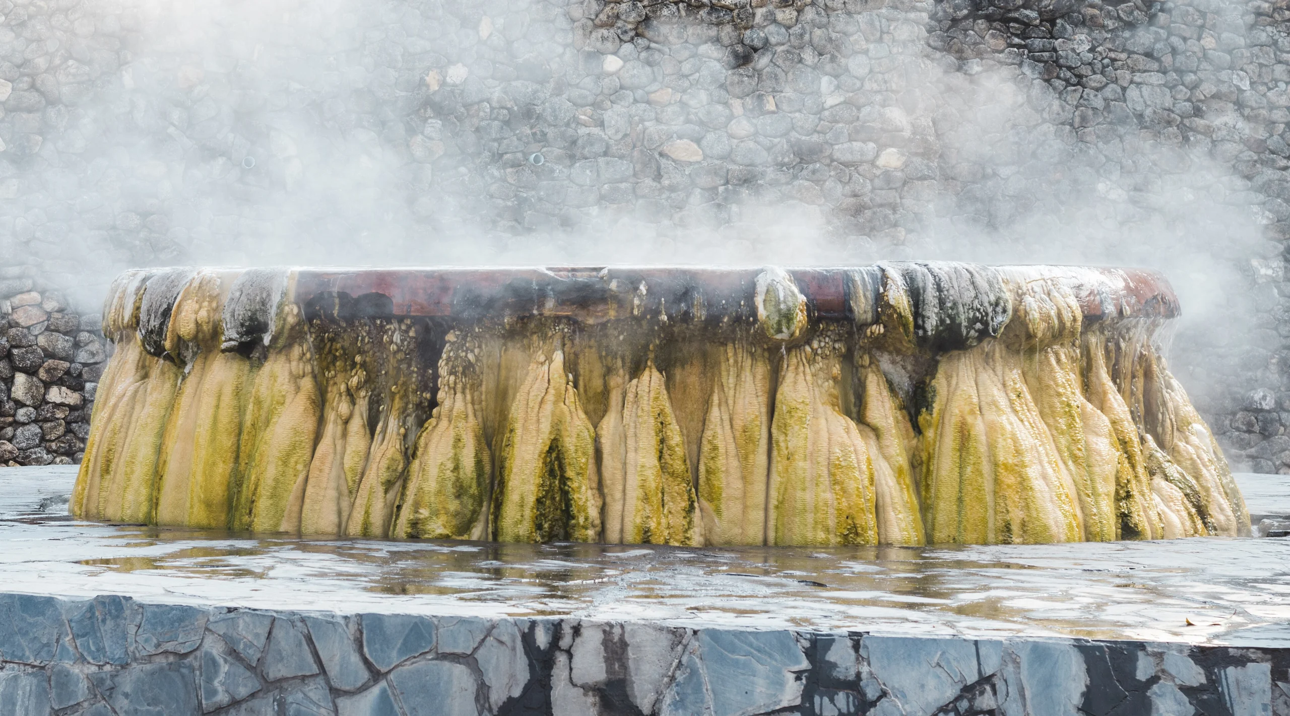 Steaming mineral mound at Raksawarin hot springs in Ranong town