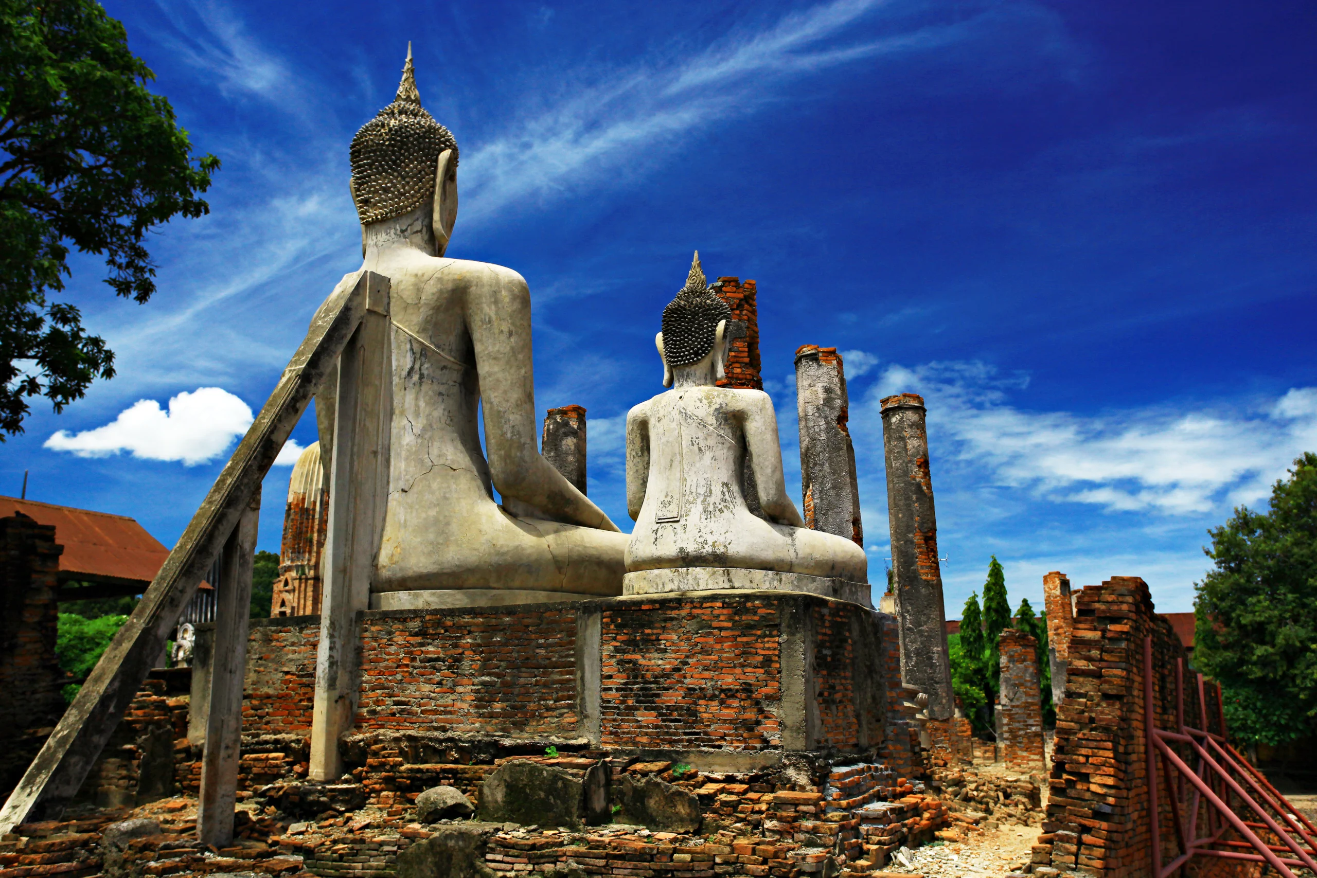 The brick ruins and white Buddha images of Wat Mahathat at Sankhaburi, Chai Nat