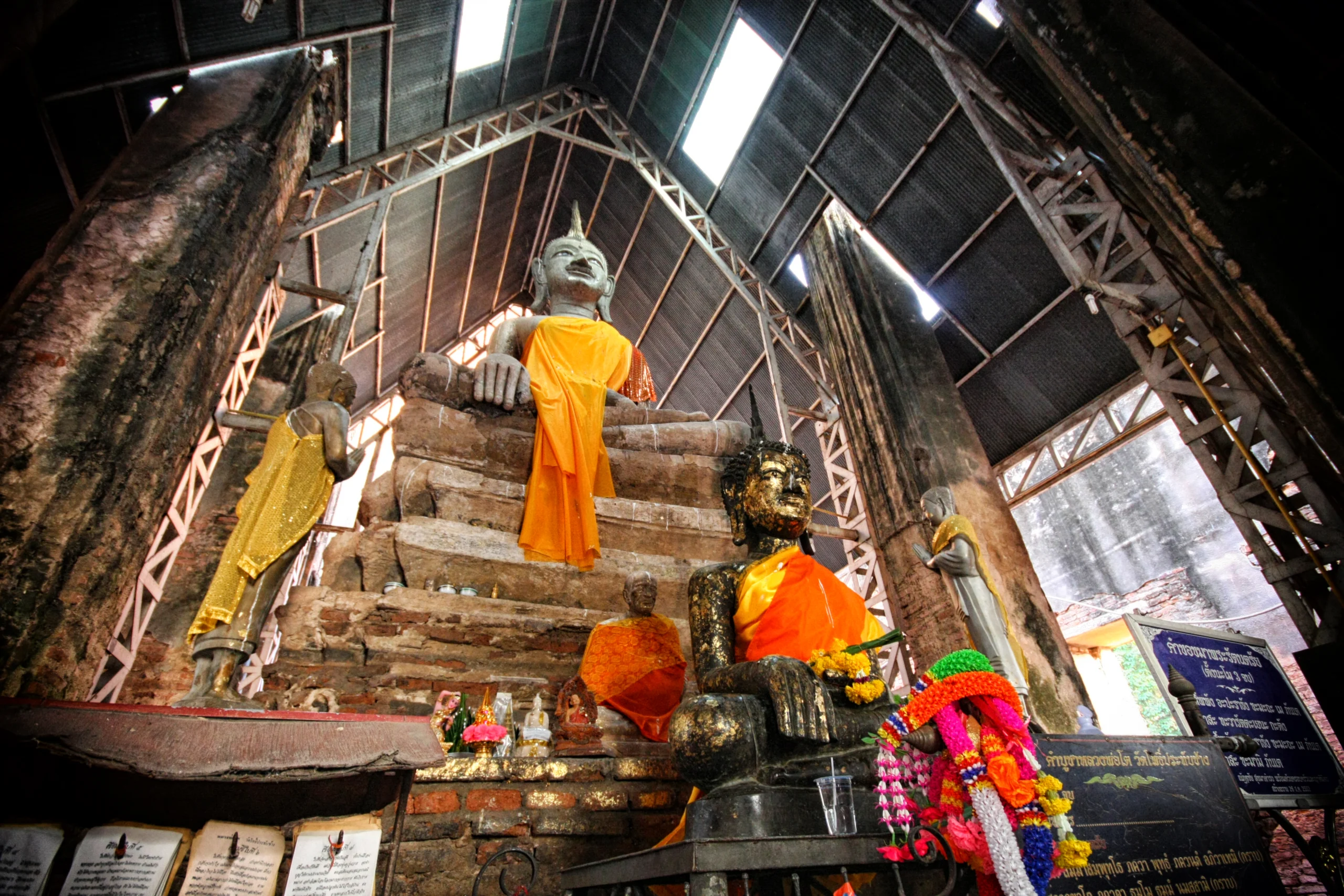 Buddha images inside the ruined ordination hall of Wat Pho Prathap Chang, Phichit