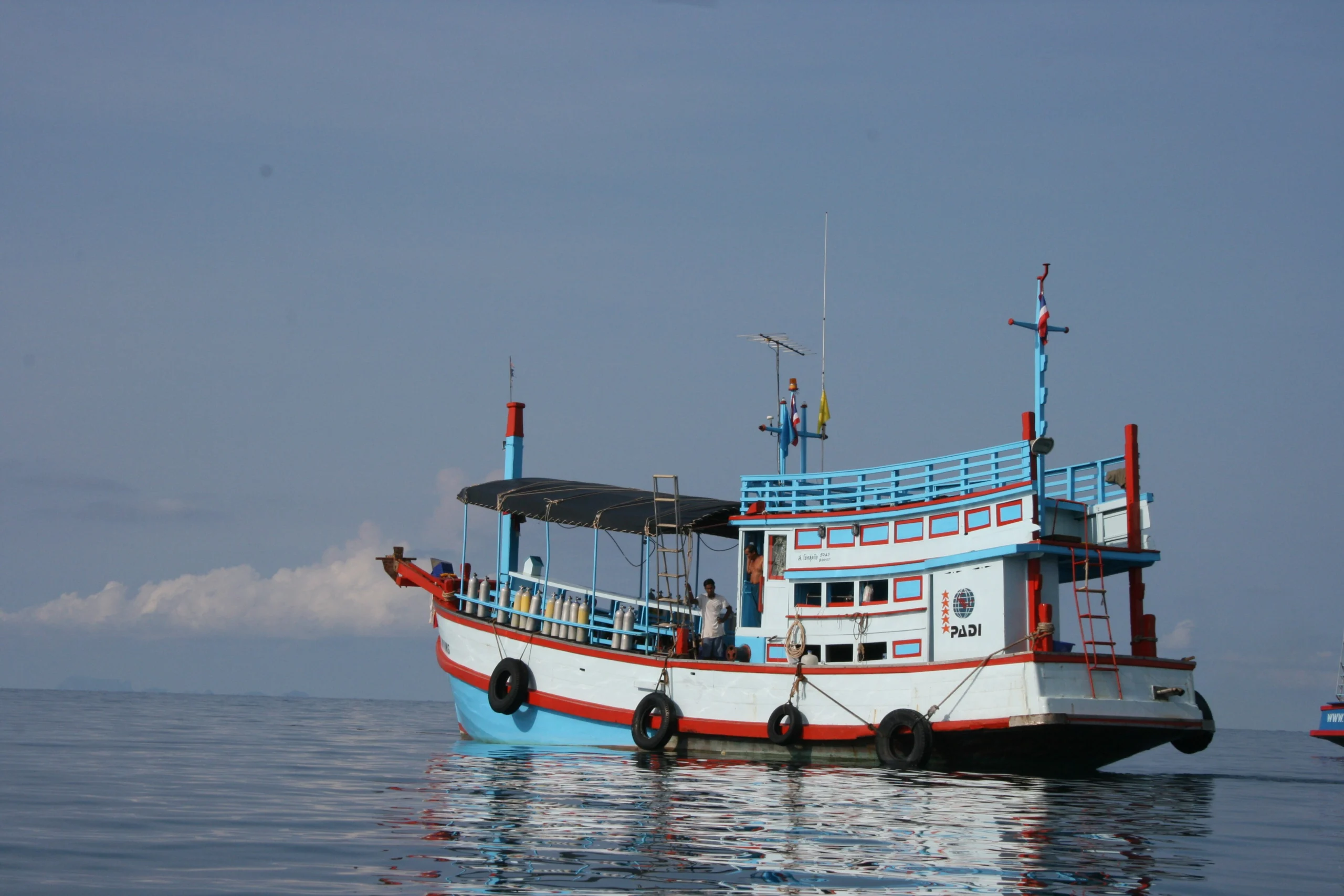 A Koh Tao dive boat loaded with tanks — the daily commute