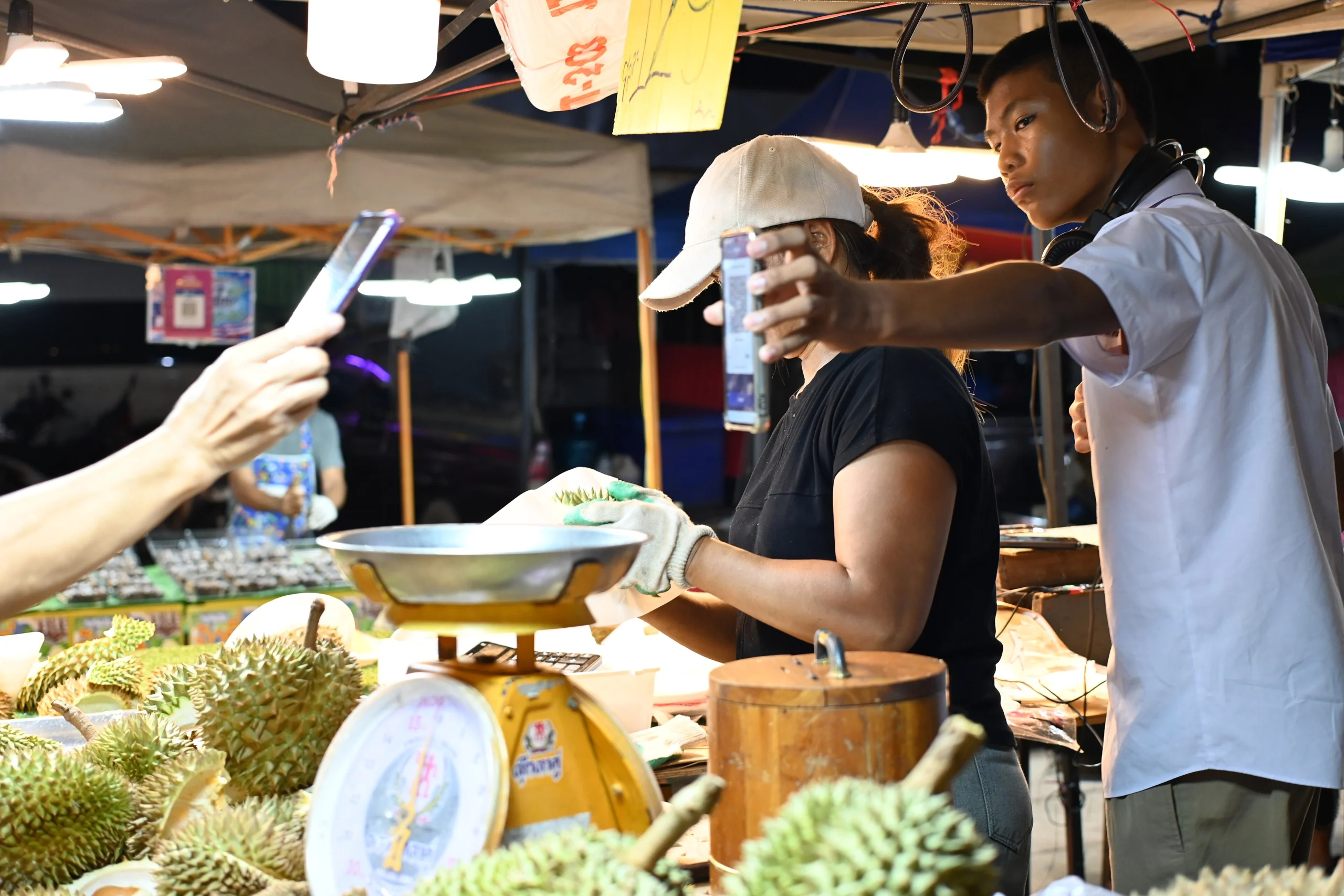 Phones do the paying at a Thai night market — data is not optional here