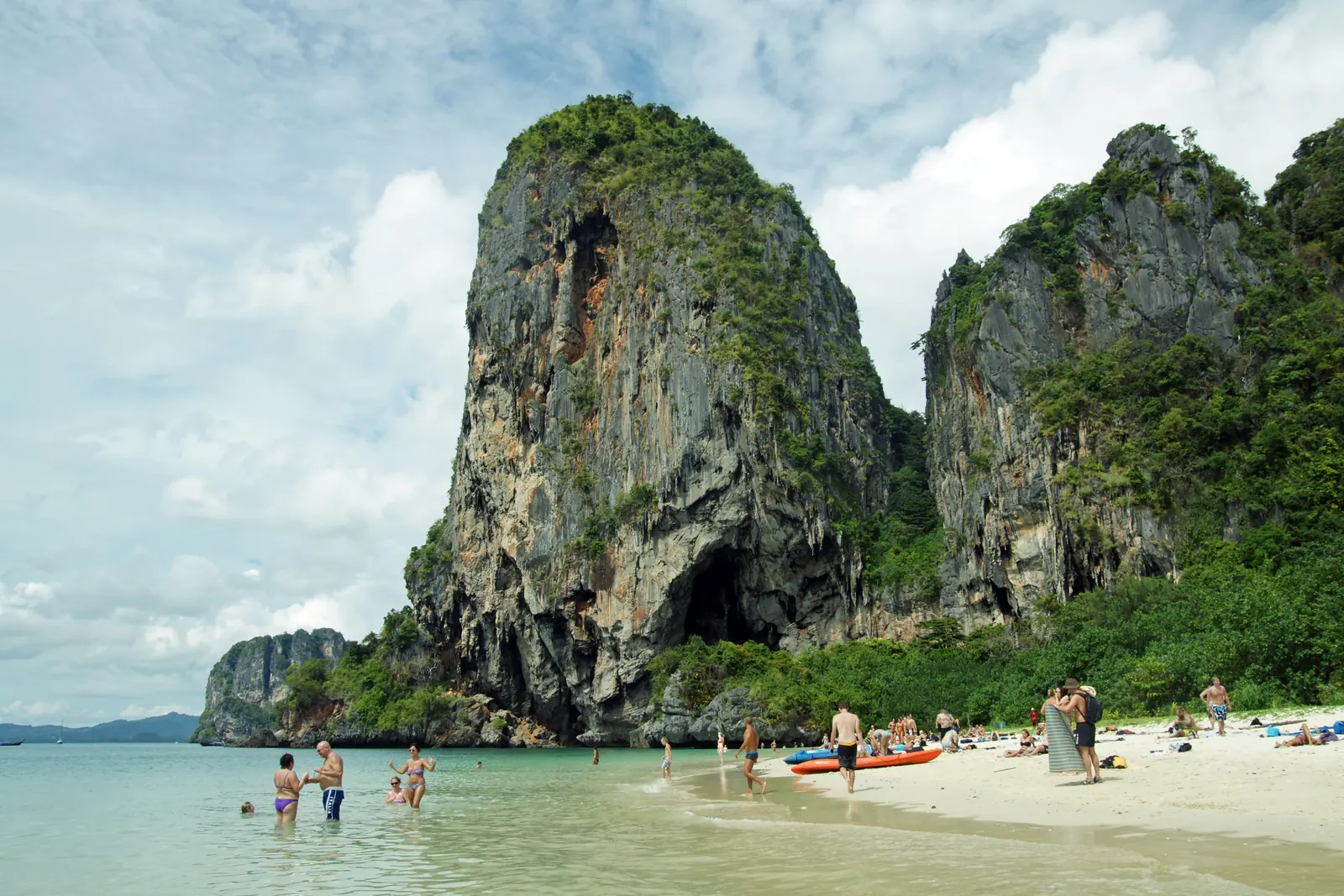 Phra Nang Beach at Railay, Krabi — limestone cliff, kayaks and swimmers on the sand