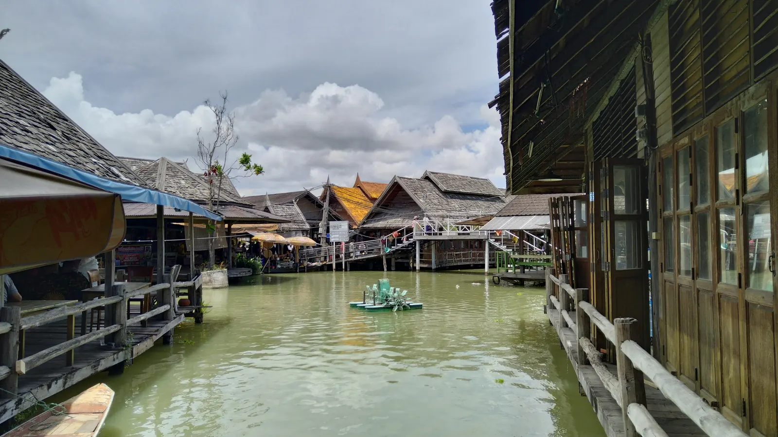 Wooden walkways and stilted shops along the canal at the Pattaya Floating Market