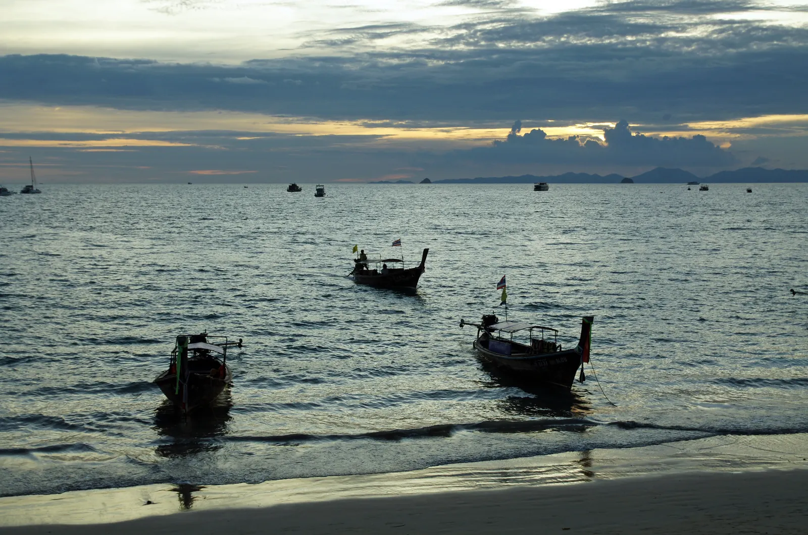 Longtail boats at dusk off Ao Nang beach, Krabi