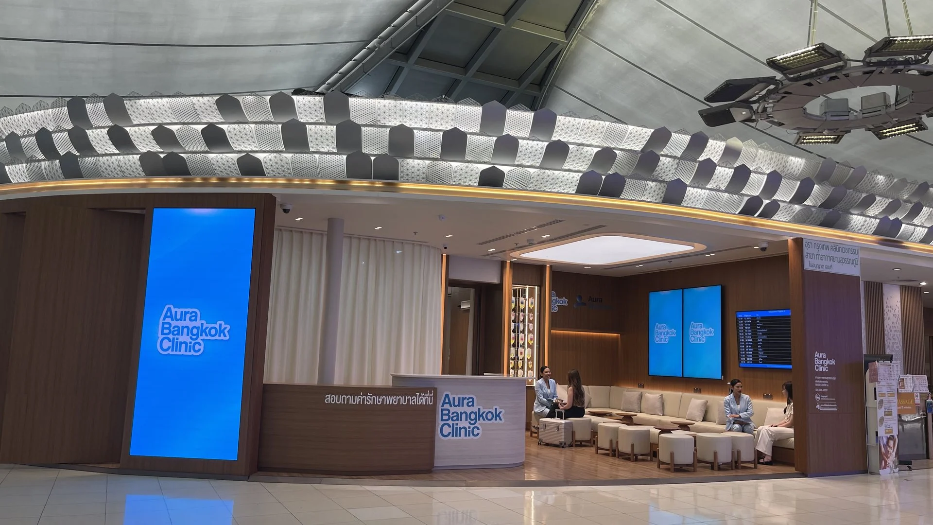 Aura Bangkok Clinic Suvarnabhumi Airport branch frontage with reception and waiting lounge in Concourse G
