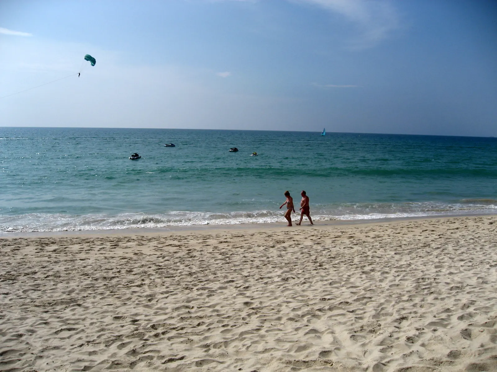 Bang Tao beach, Phuket, a long flat stretch of sand with trees behind it