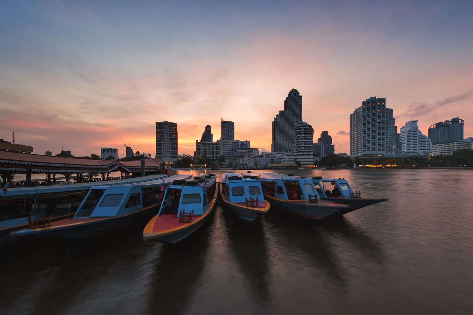 The Chao Phraya River in Bangkok with the riverside luxury hotels and the Thonburi skyline