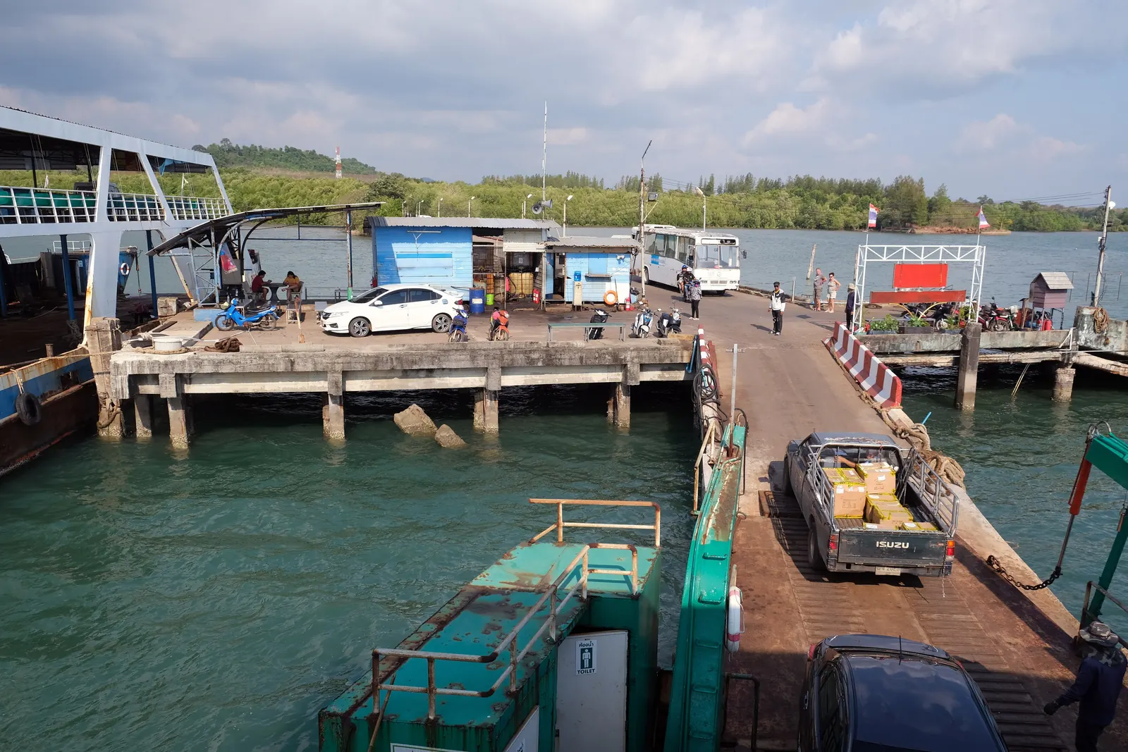 A Trat mainland ferry pier with a Koh Chang ferry alongside