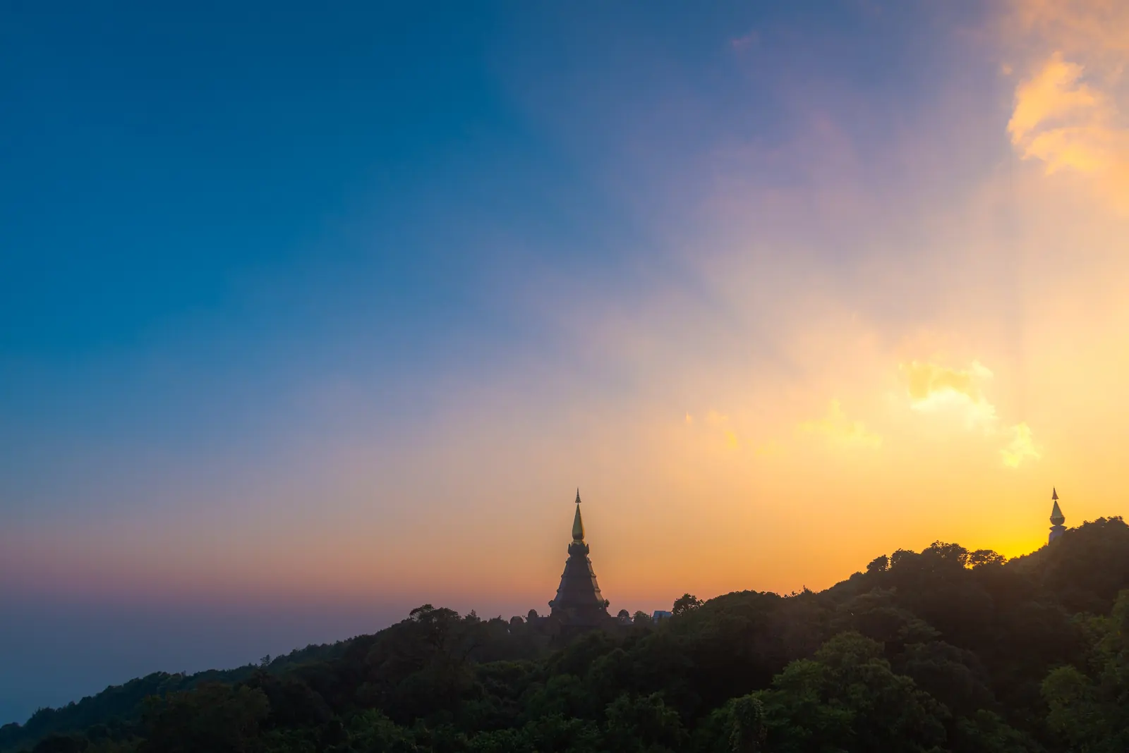 The summit pagoda on Doi Inthanon, Chiang Mai, silhouetted against a sunset sky