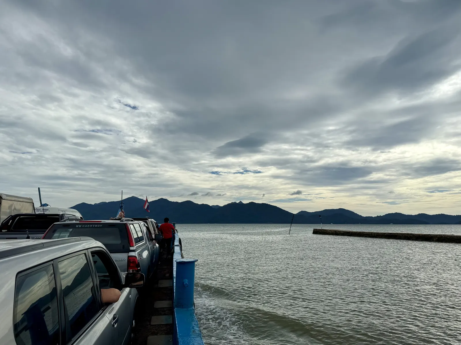 A Koh Chang car ferry with vehicles on the open deck crossing from the mainland
