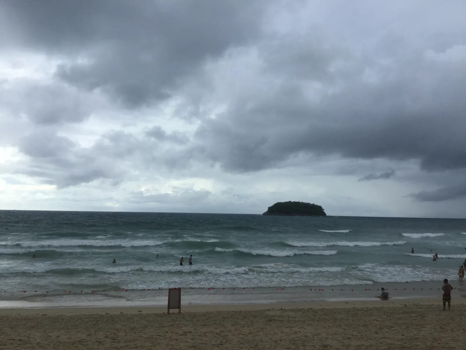 Grey monsoon cloud over Kata Beach, Phuket, with rough sea and Koh Pu offshore