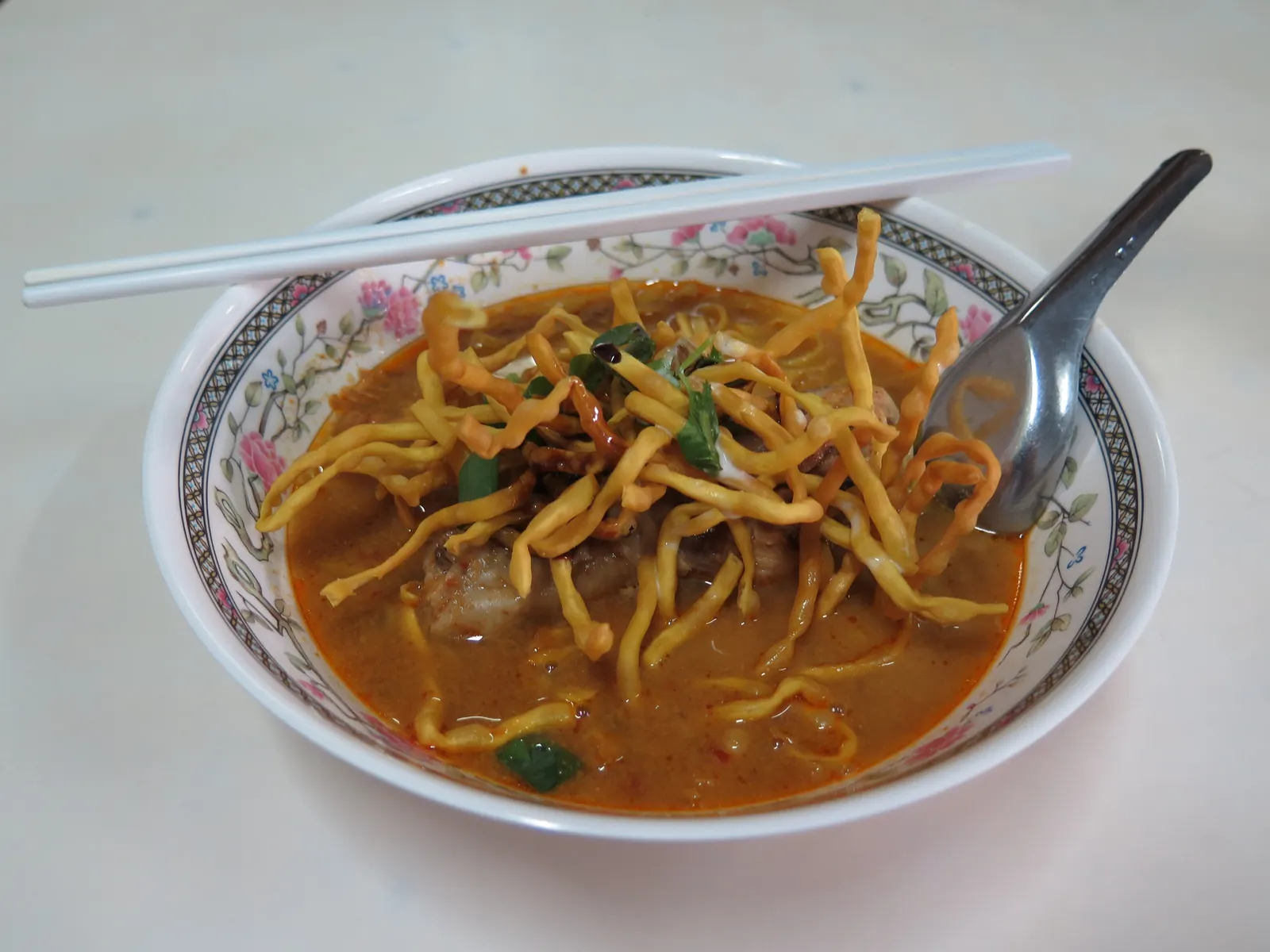 A bowl of khao soi, Chiang Mai's curry noodle soup with crispy noodles on top