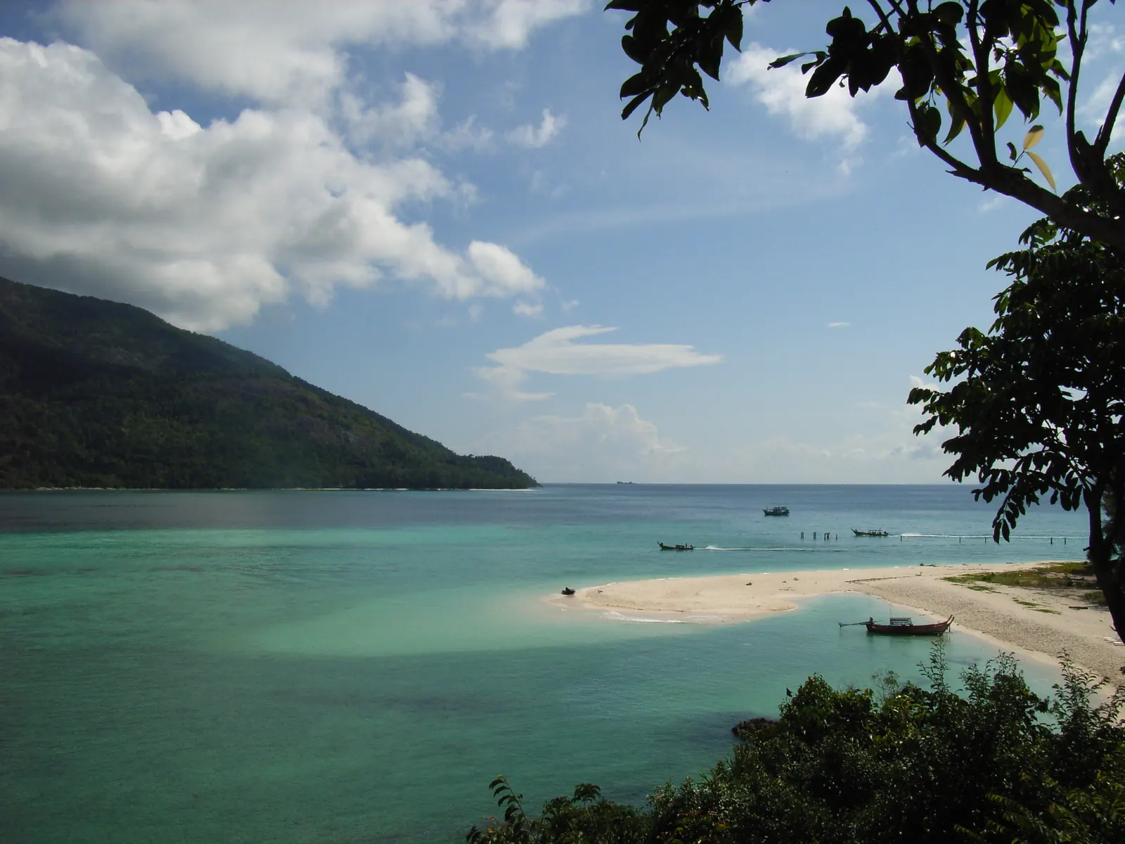 A white sand spit on Koh Lipe with Koh Adang's forested hills across the channel