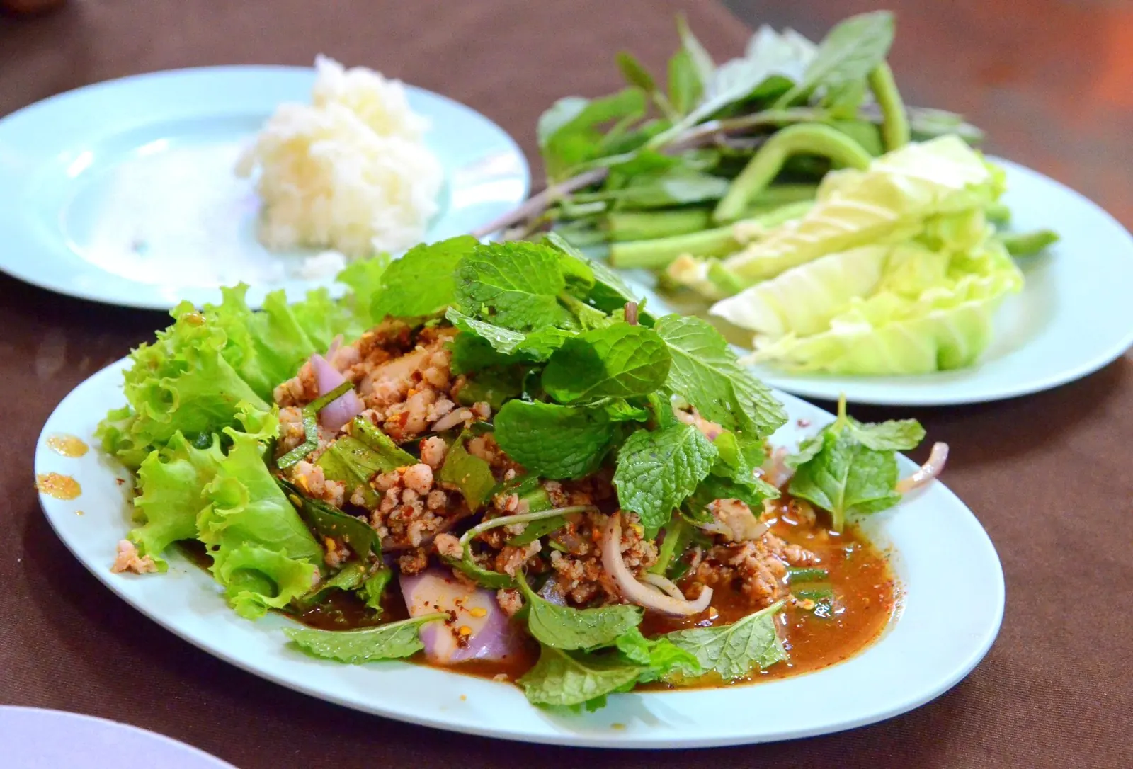 Larb mu, Isaan minced pork salad, with sticky rice and fresh vegetables