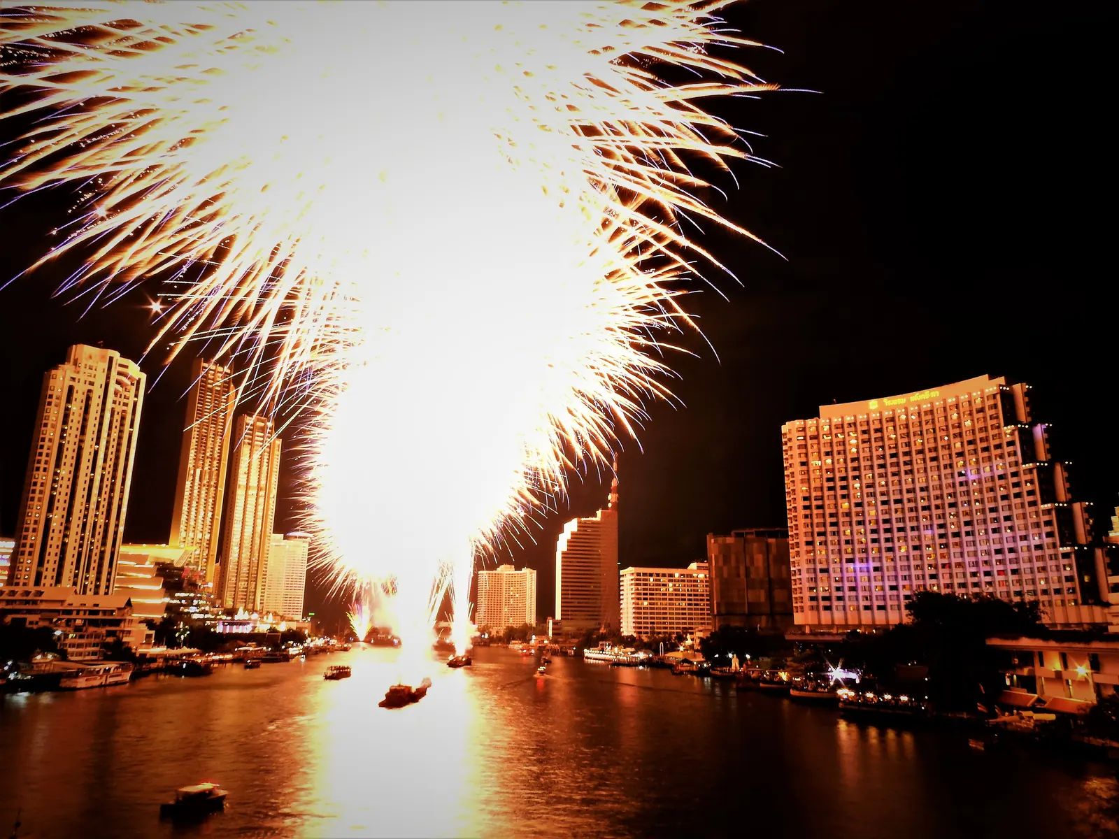 New Year's Eve fireworks over the Chao Phraya River and the Bangkok skyline