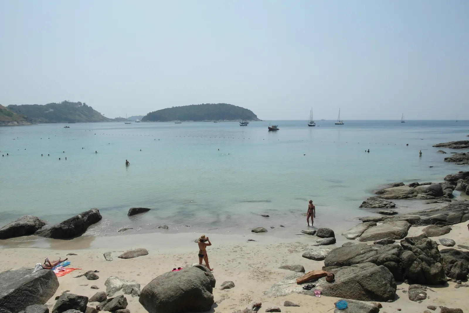 Calm water and moored boats at Nai Harn Beach in southern Phuket