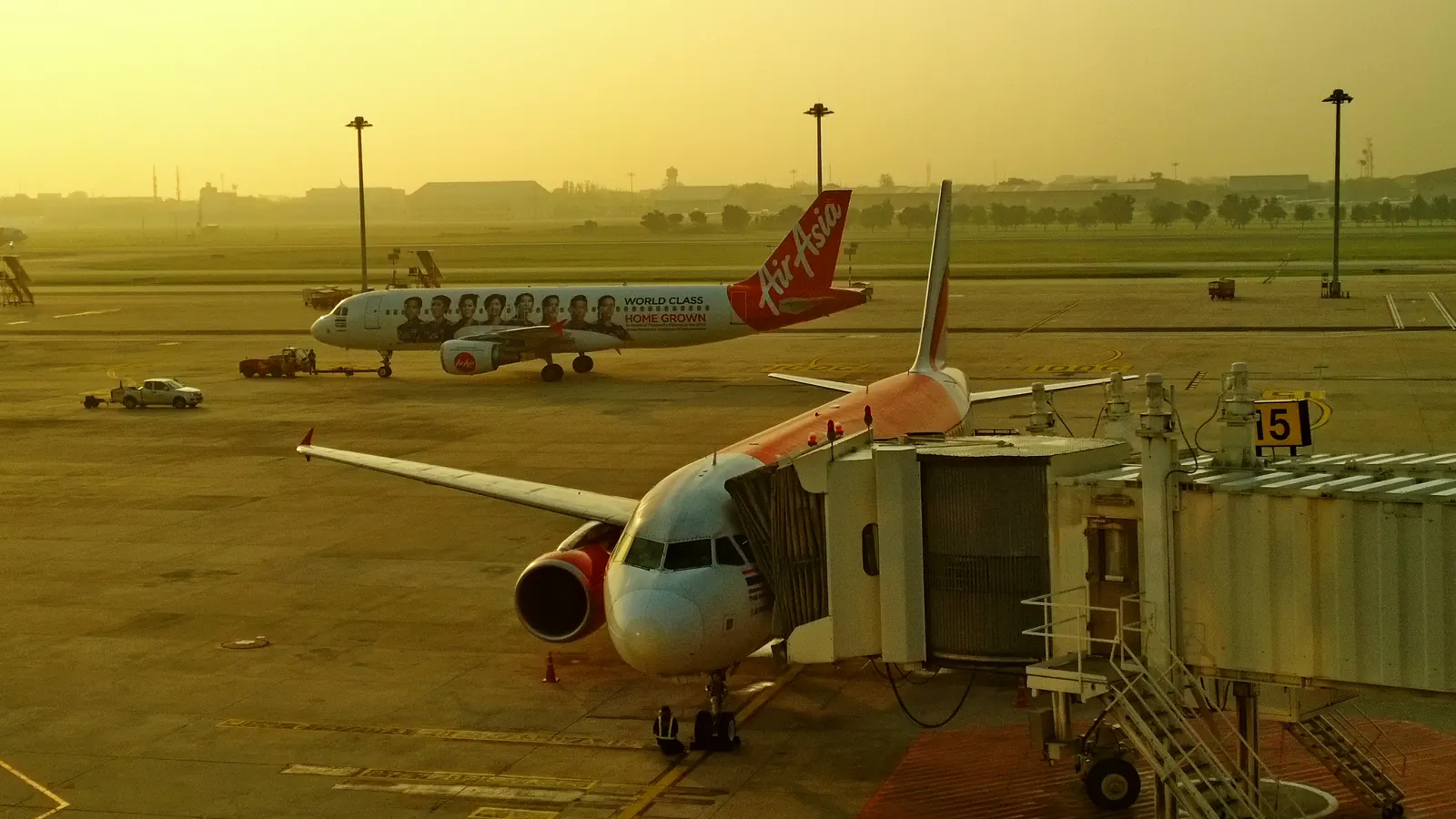 AirAsia and Nok Air aircraft parked at the gates at Don Mueang Airport, Bangkok