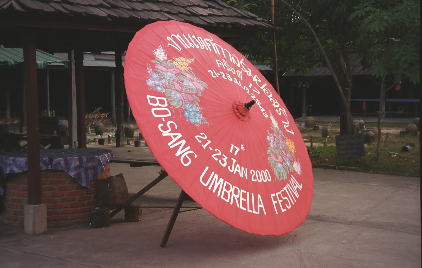 A red saa-paper umbrella printed for the Bo Sang Umbrella Festival, Chiang Mai