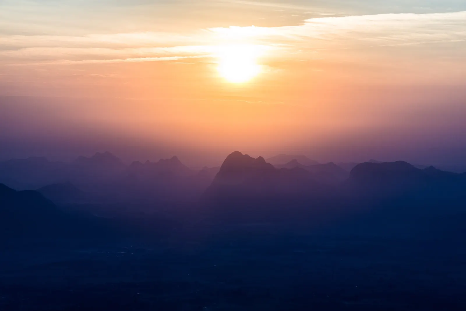 Sunrise over the mountains from Pha Nok An cliff on the Phu Kradueng plateau, Loei