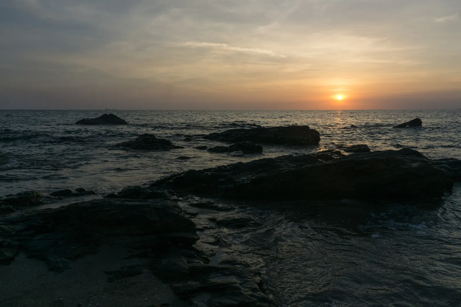 Sunset over a west-coast beach on Koh Lanta, Krabi, with longtail boats